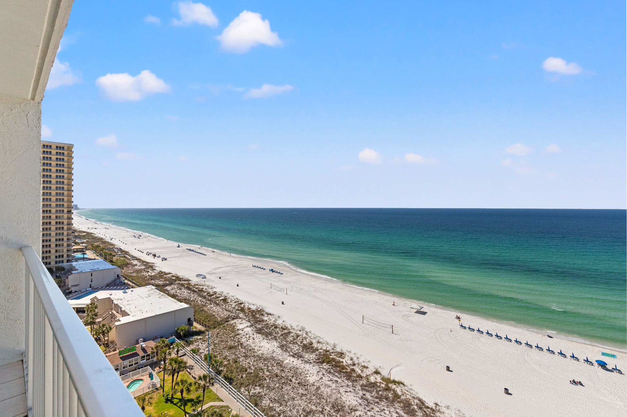 The sandy beach and Gulf shoreline viewed from a Summit condo balcony